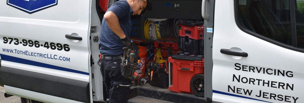 Photo of a Toth Electric licensed electrician preparing for a residential service call in Newark, New Jersey